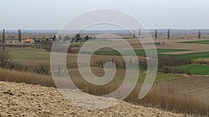 Freshly plowed field. Arable land with fertile soil for planting wheat. Rural landscape in Serbia, Balkans, namely Fruska Gora