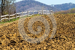 Freshly plowed field on a farm in the mountains