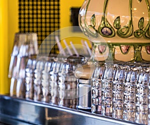 Freshly rinsed clean beer glasses stand on a counter and wait for the drinkers, intentionally low depth of focus