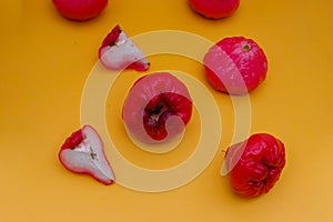 Freshly rose apple fruit isolated on orange background.