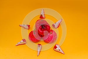 Freshly rose apple fruit isolated on orange background.