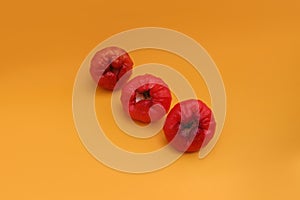 Freshly rose apple fruit isolated on orange background.