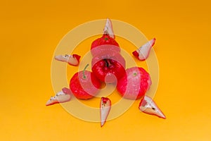 Freshly rose apple fruit isolated on orange background.