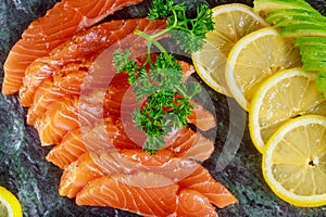 Freshly salmon with lime, avocado on a marble plate horizontal