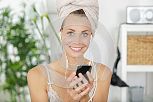 freshly showered woman listening to earphones