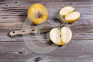 Freshly sliced golden apple on rustic wooden boards