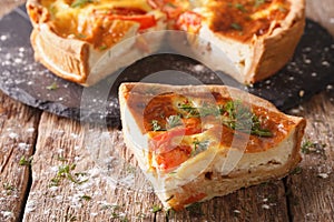 Freshly sliced pie with feta, tomatoes and herbs closeup. horizontal