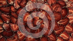 Freshly sliced red strawberries, rotates counterclockwise