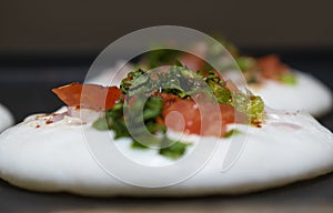 freshly sliced tomatoes and coriander on white batter