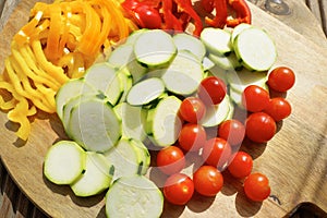 Freshly sliced vegetables on wooden board