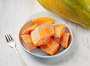 Freshly Sliced â€‹â€‹Papaya with raw fruits cut served in disposable glass isolated on background top view taiwan food