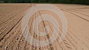 Freshly sowed spring field soil with lines, aerial view