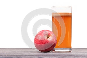 Freshly squeezed apple juice in the glass on table isolated