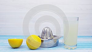 Freshly Squeezed Bio Organic Lemons With Stainless Steel Juicer And Glass Full Of Lemonade