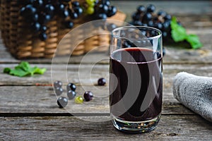 Freshly squeezed grape juice on a rustic wooden table. healthy eating