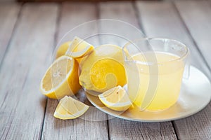 Freshly squeezed lemon juice on wooden table, copy space