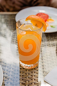 Freshly squeezed orange juice in a glass glass, morning drink