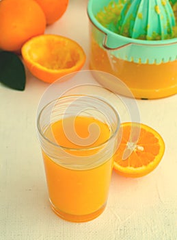 Freshly squeezed orange juice in glass on white background