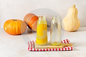 Freshly Squeezed Pumpkin Juice in Glass Bottle with Yellow Juice on Wooden Tray Napkin Vegetarian Breakfast Healthy Food