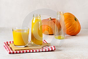 Freshly Squeezed Pumpkin Juice in Glass Bottle with Yellow Juice on Wooden Tray Napkin Vegetarian Breakfast Healthy Food Copy