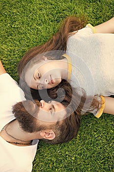 Freshness and peace. Hipster bearded man and girl happy carefree enjoy spring nature top view. Relax on spring grass