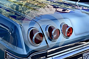 Rear red headlights of 1965 Chevy Impala Convertible at a car show in CA 2021
