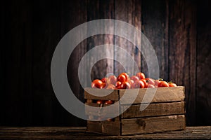 Fressh Red tomatoes box on wooden table