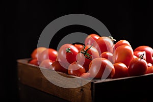 Fressh Red tomatoes box on wooden table