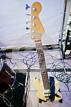 Fretboard of electric bass guitar on stage.