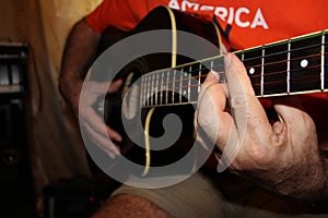 The fretboard of an old acoustic guitar