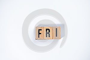 ` FRI ` text made of wooden cube on  White background