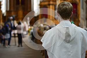 A friar standing at the end of a church