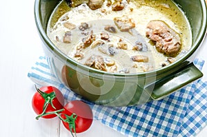 Fricassee of chicken with mushrooms in ceramic pot