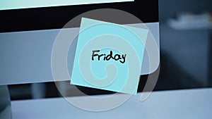Friday. Days of the week. The inscription on the sticker on the monitor.