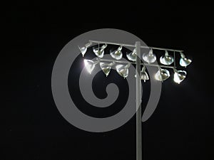 Friday night lights: Playing field floodlights against night sky