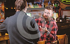 Friday relaxation in bar. Friends relaxing in bar or pub. Interesting conversation. Hipster brutal bearded man spend