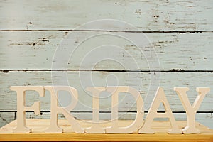 Friday word decorative letters on wooden background