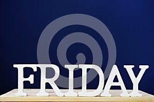 Friday word decorative letters on wooden background