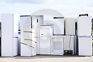 Fridge freezers outdoors at recycle depot for safe disposal refrigeration equipment and gas