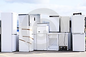 Fridge freezers outdoors at recycle depot for safe disposal refrigeration equipment and gas photo