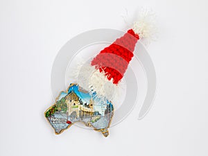 Fridge magnet in form of Australia country with inscription Melbourn, Santa hat