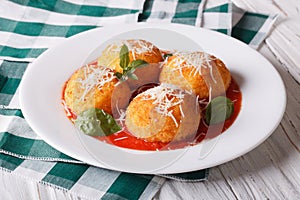 Fried arancini rice balls with tomato sauce on the table. horizo