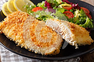 Fried Arctic char fish fillet in breadcrumbs and fresh vegetable