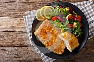 Fried Arctic char fish fillet in breadcrumbs and fresh vegetable