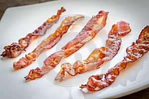 Fried bacon strips on the square plate