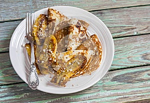Fried bananas and pancakes with honey and almonds. Tasty breakfast, snack or dessert.
