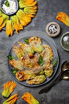 Fried in a batter Zucchini Flowers stuffed with ricotta cheese and parsley. Roasted courgette or pumpkin flowers.