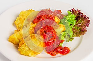 Fried battered fish fillet on white plate