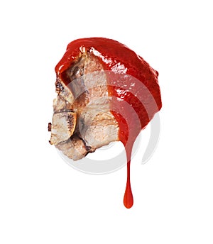Fried beef steak poured with tomato ketchup close up isolated on a white background