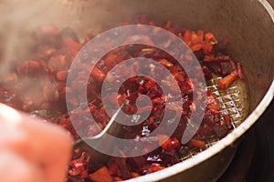 Fried beet slices on a cast-iron frying pan.